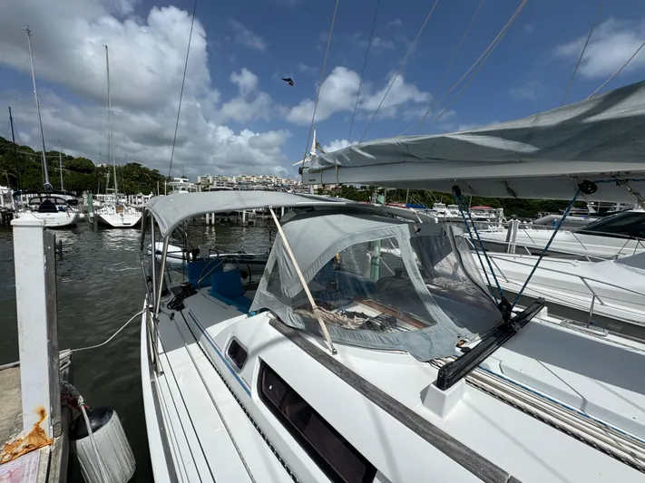 Pelican Pat Yacht Photos Pics Jeanneau Sun Odyssey 42i sailboat docked at marina, 2010 model, under clear blue sky.