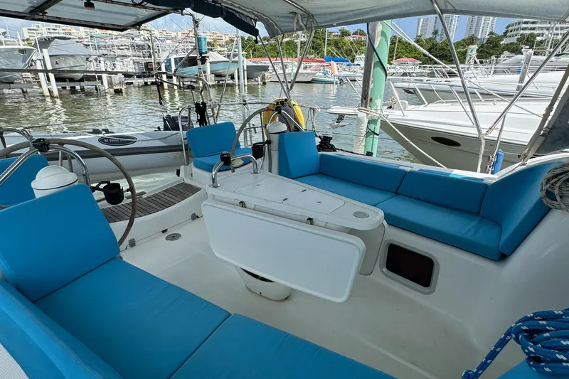 Pelican Pat Yacht Photos Pics Jeanneau Sun Odyssey 42i 2010 sailboat cockpit with blue seating, docked at marina.