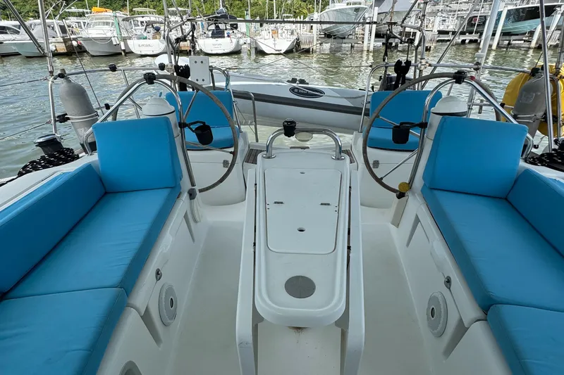 Pelican Pat Yacht Photos Pics Cockpit of 2010 Jeanneau Sun Odyssey 42i with blue cushions and dual steering wheels.