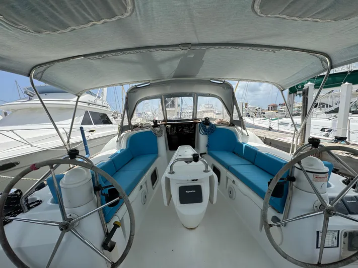 Pelican Pat Yacht Photos Pics Cockpit of 2010 Jeanneau Sun Odyssey 42i sailboat with blue seating and dual steering wheels.