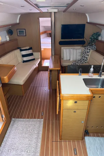 Pelican Pat Yacht Photos Pics Interior of 2010 Jeanneau Sun Odyssey 42i yacht with modern furnishings and wood finish.