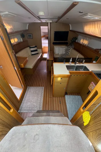 Pelican Pat Yacht Photos Pics Interior of 2010 Jeanneau Sun Odyssey 42i yacht, featuring cozy seating, kitchen, and modern amenities.