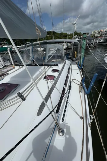 Pelican Pat Yacht Photos Pics Jeanneau Sun Odyssey 42i sailboat docked, showcasing deck and rigging under cloudy sky.