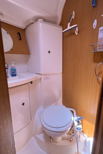 Pelican Pat Yacht Photos Pics Compact bathroom in 2010 Jeanneau Sun Odyssey 42i yacht, featuring toilet and sink.