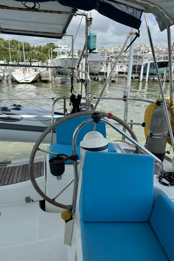 Pelican Pat Yacht Photos Pics Cockpit of 2010 Jeanneau Sun Odyssey 42i sailboat with blue seating, docked at marina.