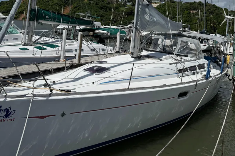 Pelican Pat Yacht Photos Pics 2010 Jeanneau Sun Odyssey 42i sailboat docked at marina, surrounded by other boats.