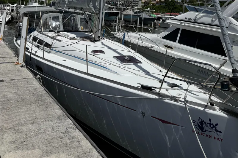 Pelican Pat Yacht Photos Pics 2010 Jeanneau Sun Odyssey 42i sailboat docked at marina, side view.