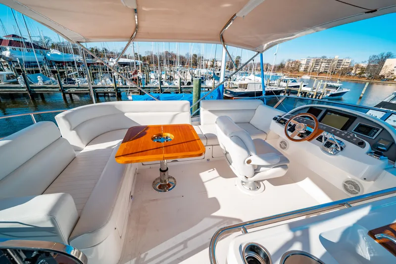  Yacht Photos Pics Luxurious 2015 Belize 54 Daybridge yacht interior with plush seating and elegant wooden table.