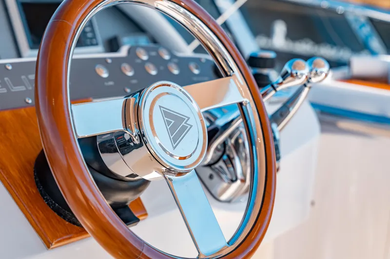  Yacht Photos Pics Steering wheel of a 2015 Belize 54 Daybridge yacht, featuring polished metal and wood accents.