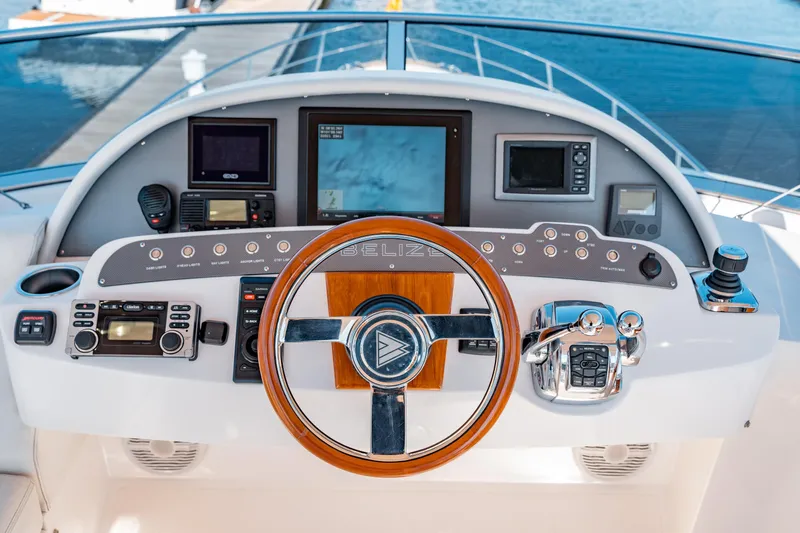  Yacht Photos Pics Helm of 2015 Belize 54 Daybridge yacht with advanced navigation controls and wooden steering wheel.
