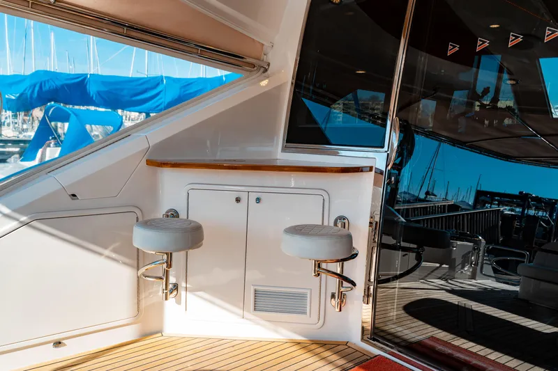  Yacht Photos Pics 2015 Belize 54 Daybridge yacht interior with bar stools and marina view.