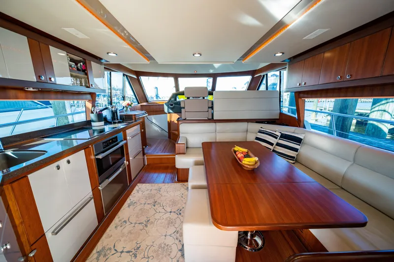  Yacht Photos Pics Luxurious interior of 2015 Belize 54 Daybridge yacht with modern kitchen and dining area.