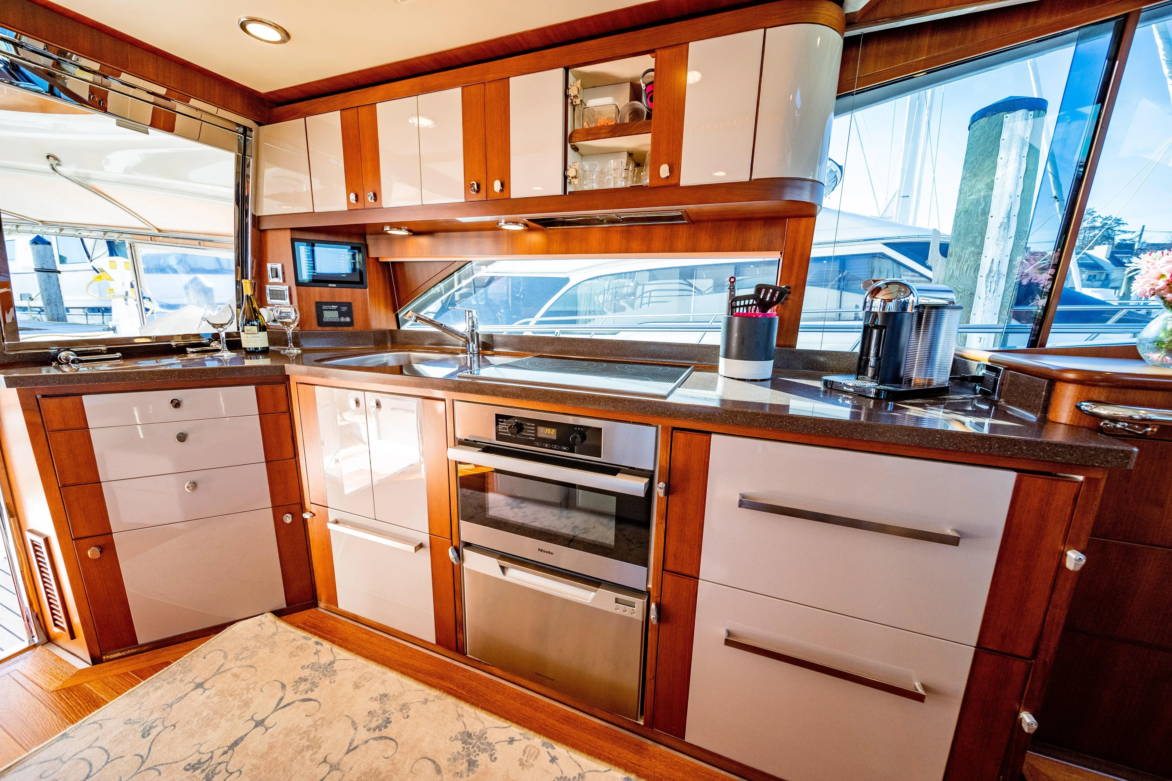  Yacht Photos Pics Luxurious kitchen interior of 2015 Belize 54 Daybridge yacht with modern appliances and wood cabinetry.
