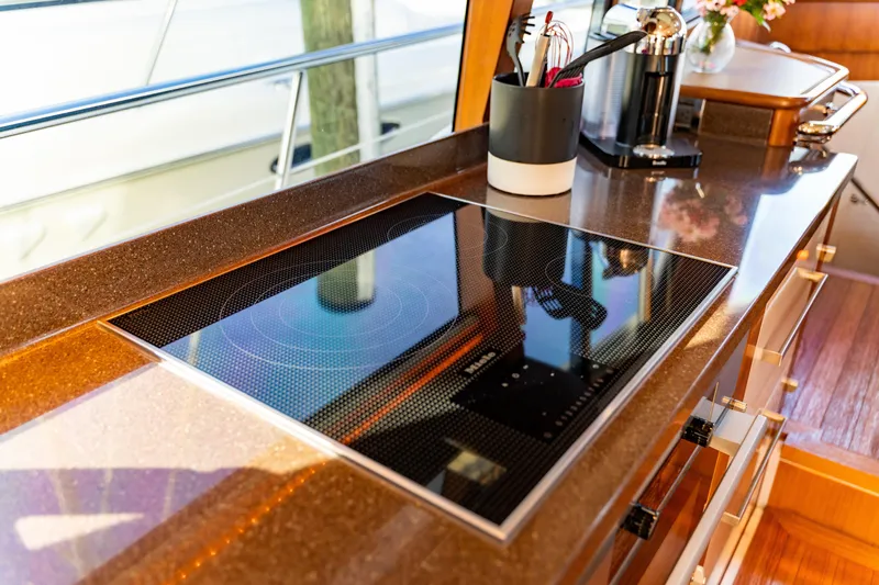  Yacht Photos Pics Luxurious kitchen area on a 2015 Belize 54 Daybridge yacht with modern stovetop.