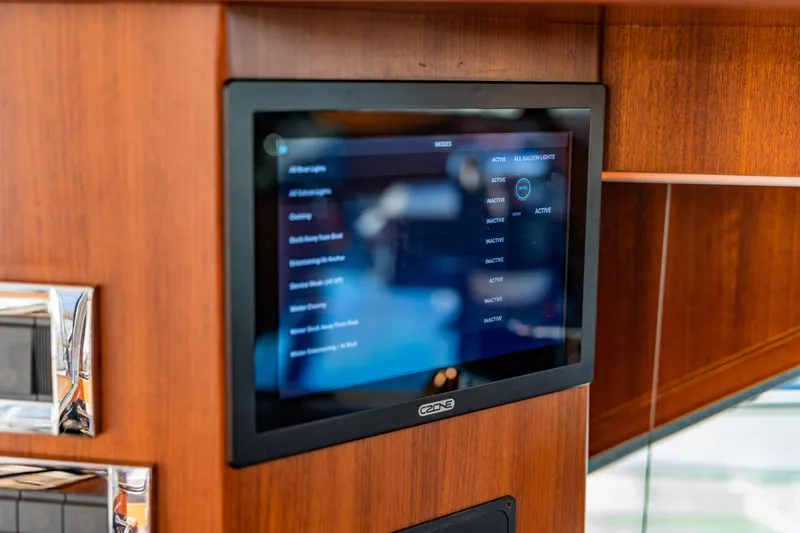  Yacht Photos Pics Touchscreen control panel on 2015 Belize 54 Daybridge yacht, mounted on wooden interior.