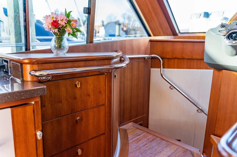  Yacht Photos Pics Luxurious interior of 2015 Belize 54 Daybridge yacht with wooden cabinetry and floral arrangement.