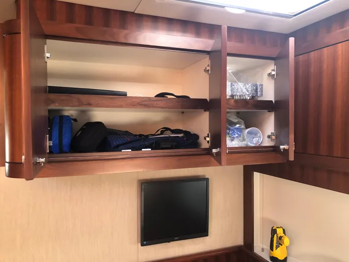  Yacht Photos Pics Open wooden cabinets in a 2015 Belize 54 Daybridge yacht interior.