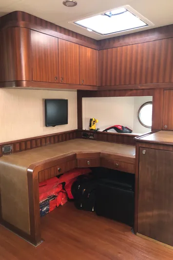  Yacht Photos Pics Interior of a 2015 Belize 54 Daybridge yacht with wood cabinetry and a small desk area.