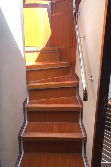  Yacht Photos Pics Staircase inside 2015 Belize 54 Daybridge yacht with wooden steps and metal handrail.