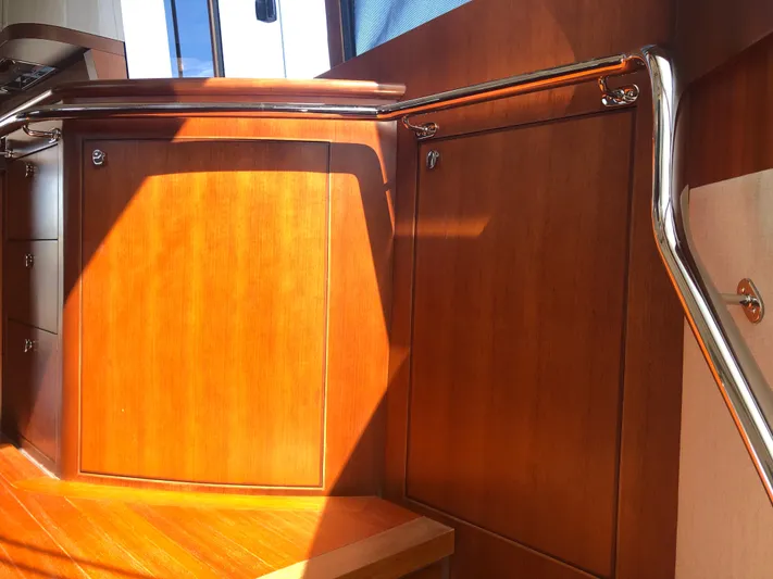  Yacht Photos Pics Interior of 2015 Belize 54 Daybridge yacht with wooden cabinetry and stainless steel railings.