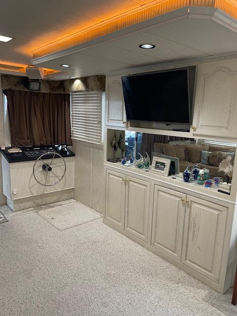 Interior of a 2000 Funtime 16x72 houseboat with modern decor and entertainment setup.