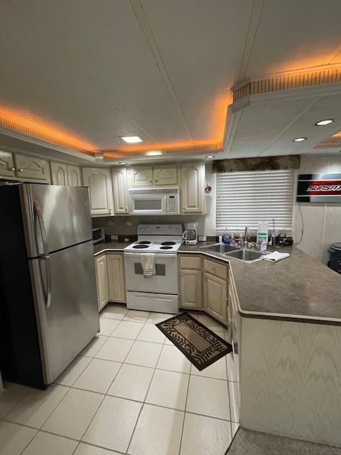 Modern kitchen in a 2000 Funtime 16x72 houseboat with stainless steel appliances and ambient lighting.