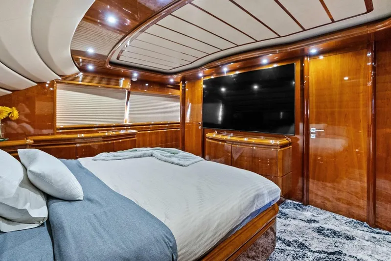 Noah's Yacht Photos Pics Luxurious bedroom interior of 2004 Ferretti Yachts 94 Motor Yacht with elegant wood finishes.