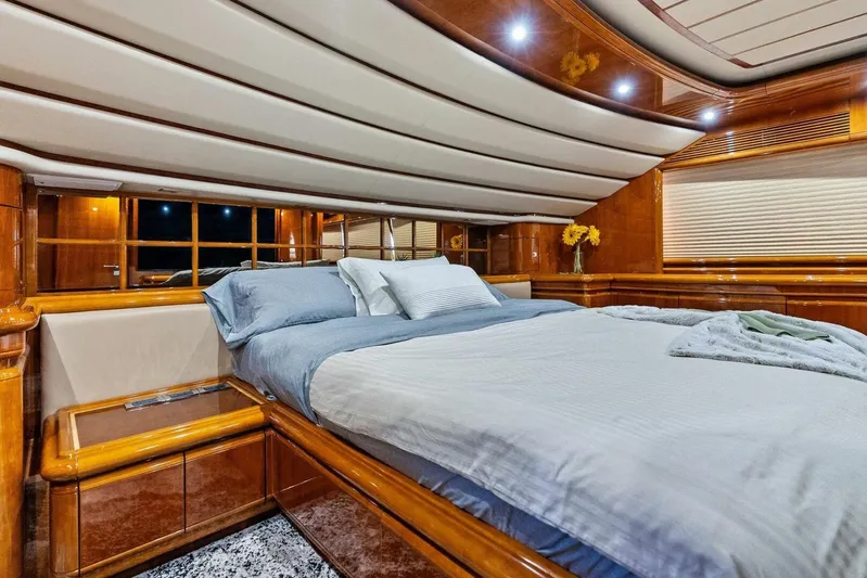 Noah's Yacht Photos Pics Luxurious bedroom interior of 2004 Ferretti Yachts 94 Motor Yacht with elegant wood finish.
