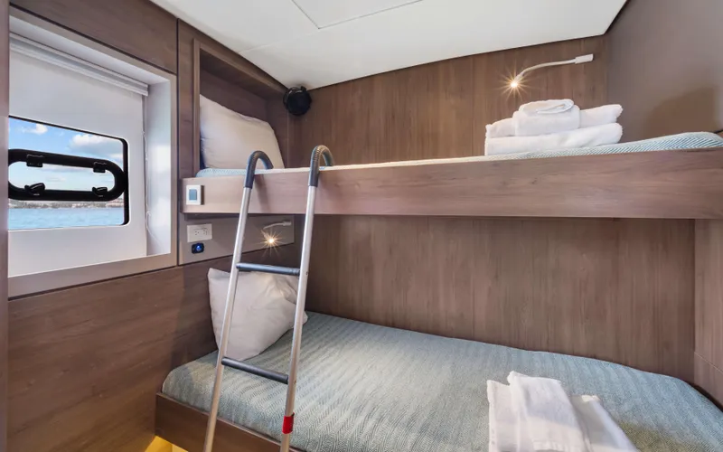 Always Sunday Yacht Photos Pics Bali 4.8 yacht cabin with bunk beds, window view, and modern wooden interior, 2022 model.