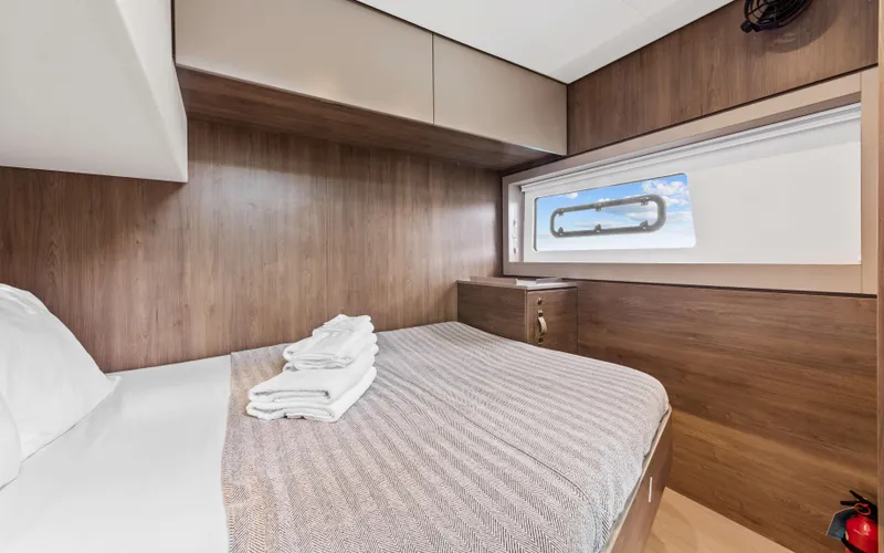 Always Sunday Yacht Photos Pics Luxurious cabin interior of 2022 Bali 4.8 yacht with wooden finish and window view.