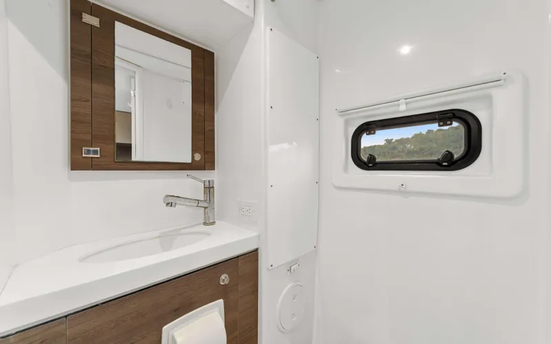 Always Sunday Yacht Photos Pics Modern bathroom in 2022 Bali 4.8 yacht with mirror, sink, and window.