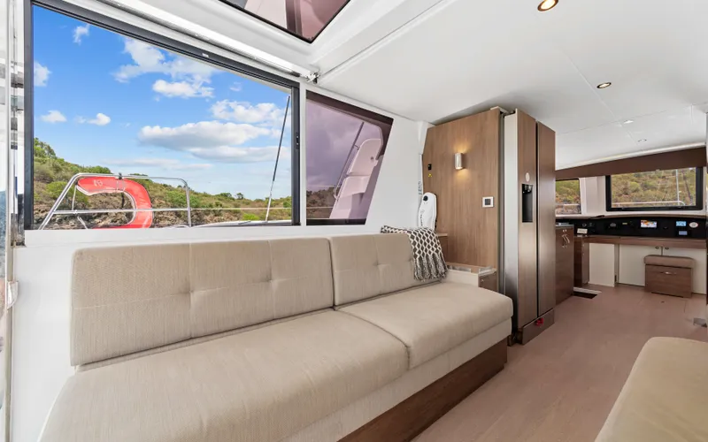 Always Sunday Yacht Photos Pics Luxurious interior of 2022 Bali 4.8 yacht with modern furnishings and scenic window view.