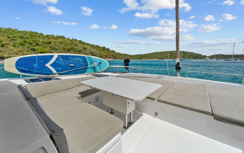 Always Sunday Yacht Photos Pics Luxurious Bali 4.8 yacht deck with paddleboard, scenic ocean view, and comfortable seating, 2022 model.