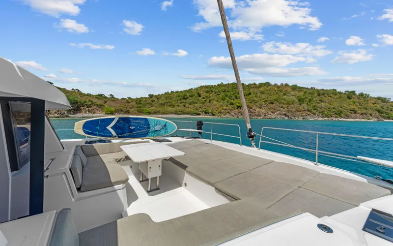 Always Sunday Yacht Photos Pics Luxurious Bali 4.8 yacht deck with seating, table, and scenic ocean view, 2022 model.