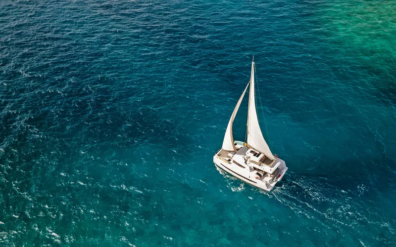 Always Sunday Yacht Photos Pics Sailing catamaran Bali 4.8, 2022 model, cruising on clear blue ocean waters.