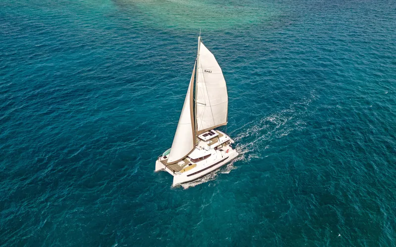 Always Sunday Yacht Photos Pics Sailing catamaran Bali 4.8, 2022 model, cruising on clear blue ocean waters.