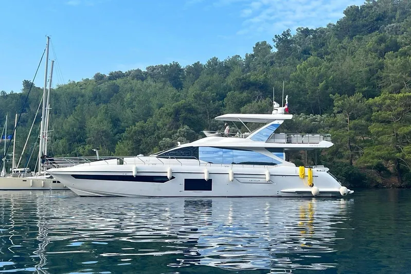  Yacht Photos Pics Azimut Fly 72 yacht, 2021 model, anchored in a serene, forested bay.