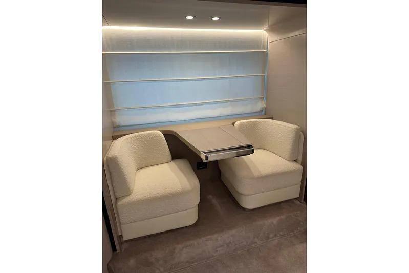 Yacht Photos Pics Luxurious interior seating area on a 2021 Azimut Fly 72 yacht, featuring plush chairs and a table.