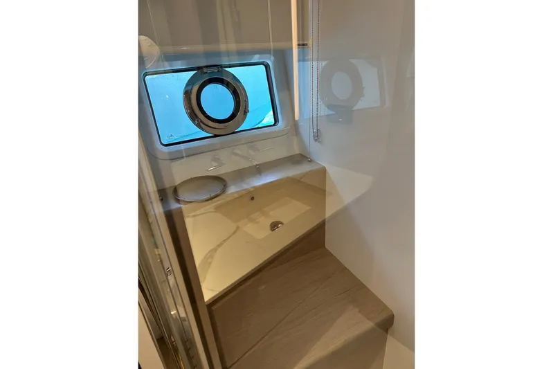  Yacht Photos Pics Luxurious bathroom interior of 2021 Azimut Fly 72 yacht with porthole window.