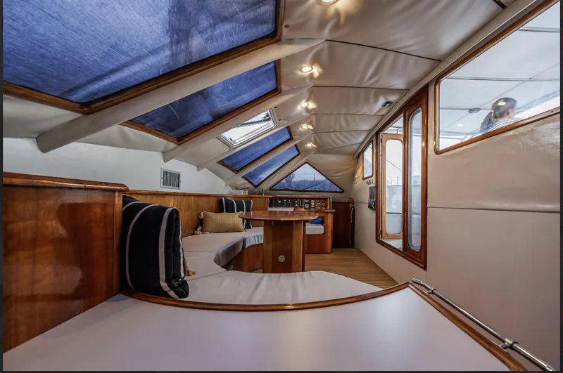Blue Star Yacht Photos Pics Interior of 1993 Privilege 43 yacht with wooden finishes and blue accents.