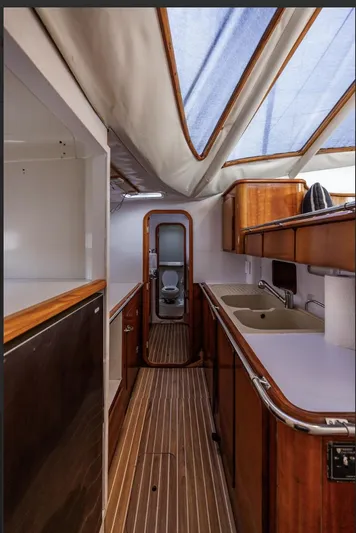 Blue Star Yacht Photos Pics Interior of 1993 Privilege 43 yacht with wooden cabinetry and skylight.