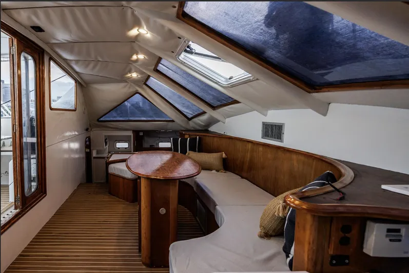 Blue Star Yacht Photos Pics Luxurious 1993 Privilege 43 yacht interior with skylights, wooden accents, and comfortable seating.