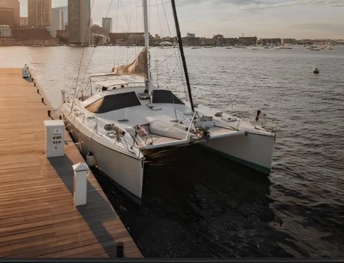 Blue Star Yacht Photos Pics Sailboat docked at marina, Privilege 43 model, 1993, with city skyline in background.