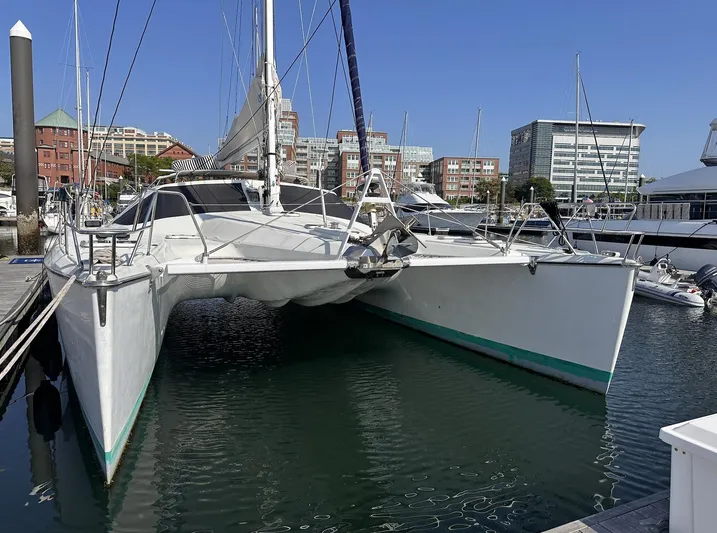 Blue Star Yacht Photos Pics Catamaran Privilege 43, 1993 model, docked in a marina with urban buildings in the background.