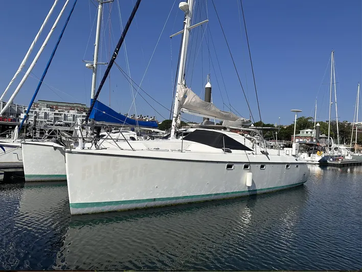 Blue Star Yacht Photos Pics Sailboat "Privilege 43" from 1993 docked in a marina under clear blue skies.