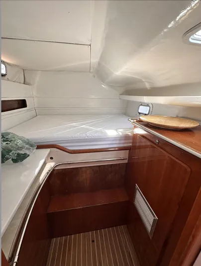Blue Star Yacht Photos Pics Cozy cabin interior of 1993 Privilege 43 yacht with wooden accents and bedding.