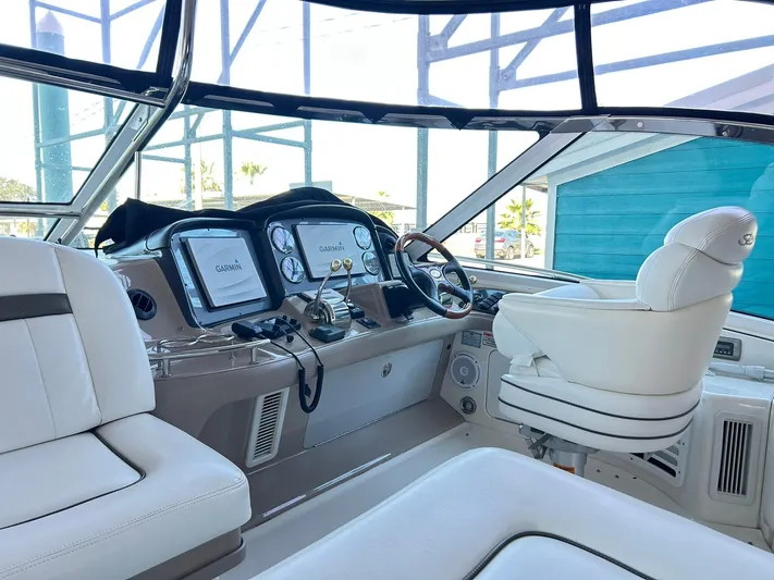 Rock It Yacht Photos Pics Helm of 2007 Sea Ray 52 Sundancer with modern navigation equipment and plush seating.