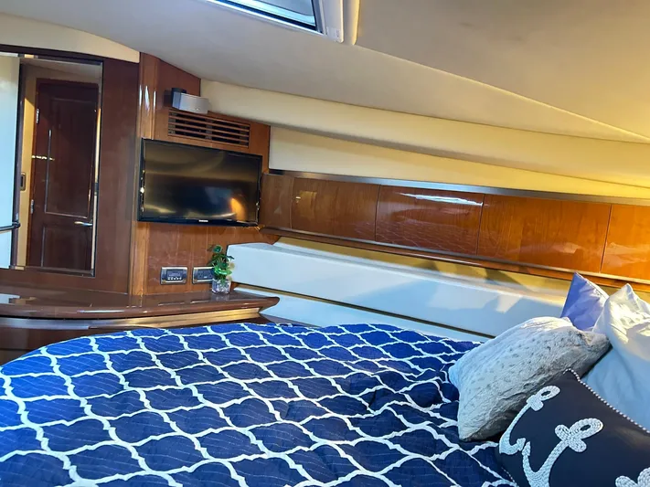 Rock It Yacht Photos Pics Luxurious cabin interior of 2007 Sea Ray 52 Sundancer yacht with cozy bedding and TV.
