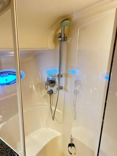 Rock It Yacht Photos Pics Shower area in 2007 Sea Ray 52 Sundancer yacht with modern fixtures and porthole windows.