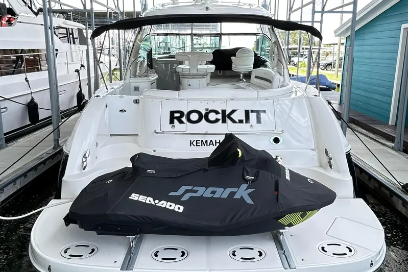 Rock It Yacht Photos Pics 2007 Sea Ray 52 Sundancer yacht with Sea-Doo Spark jet ski on deck, docked in marina.